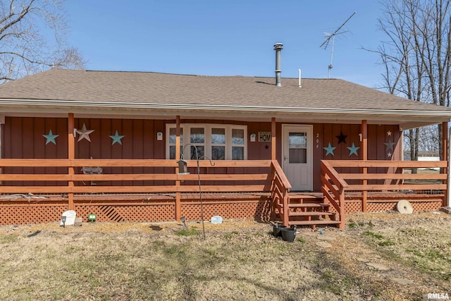 back of property featuring covered porch, board and batten siding, and roof with shingles