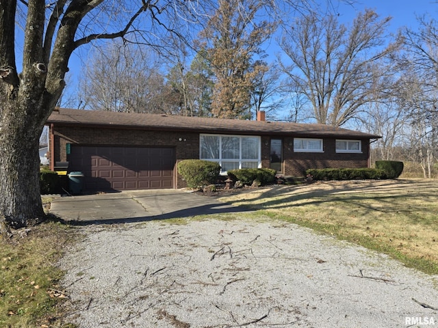 ranch-style home featuring a garage and a front lawn