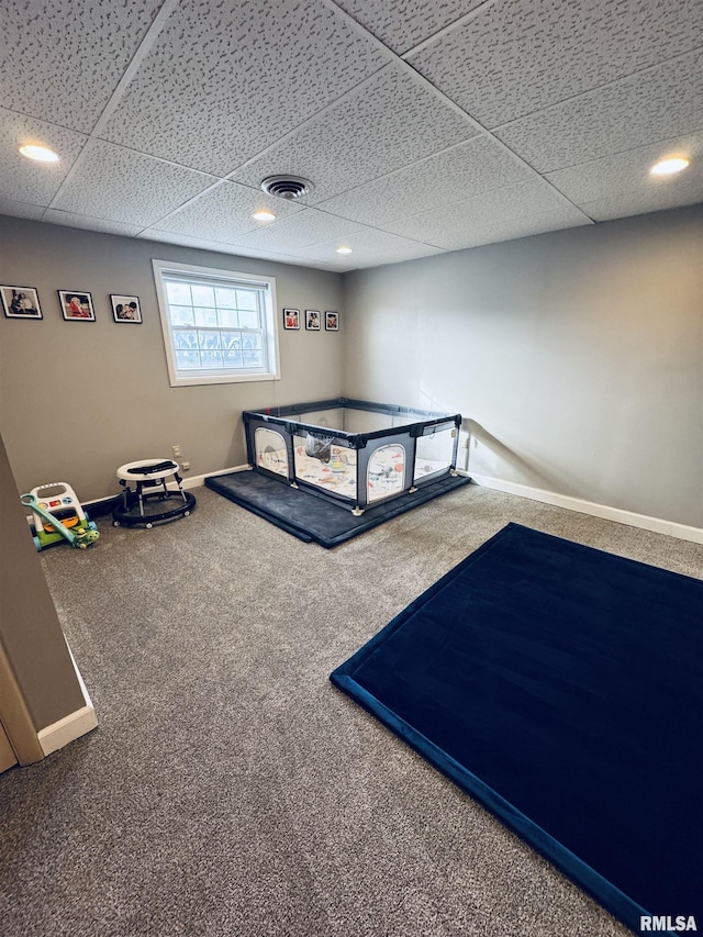 playroom featuring a paneled ceiling and carpet floors