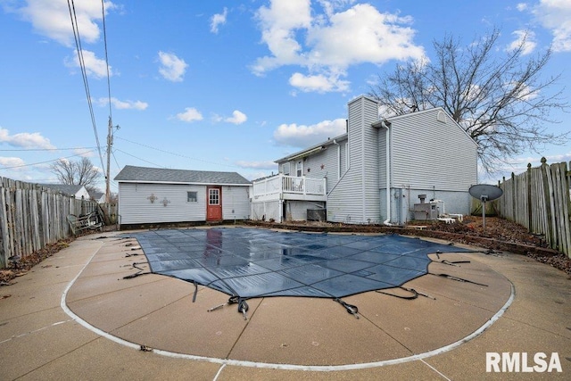 view of pool with a patio and an outdoor structure