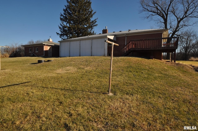 rear view of house with a yard and a wooden deck