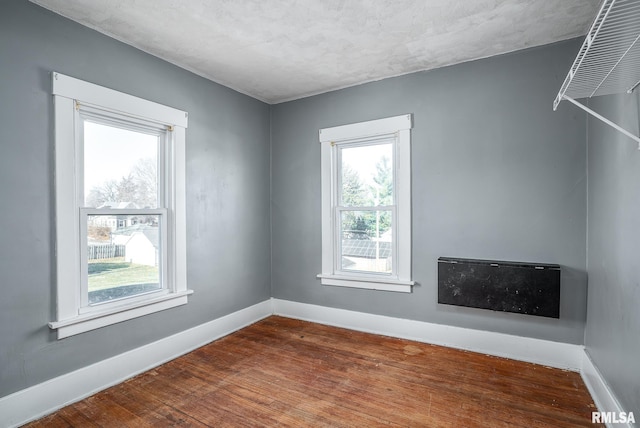 spare room with wood-type flooring