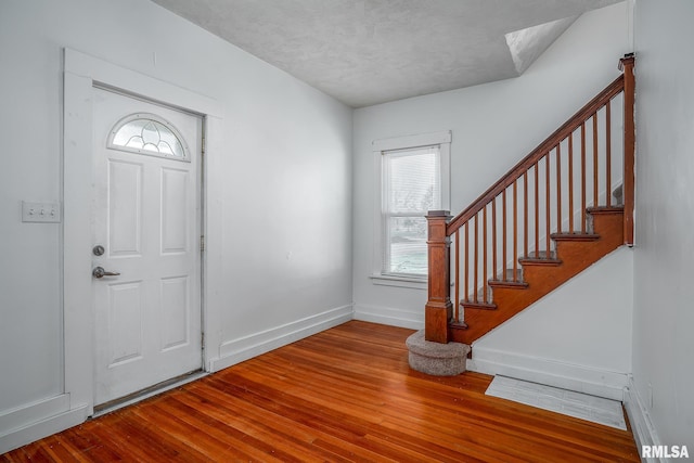 foyer with a textured ceiling and hardwood / wood-style flooring