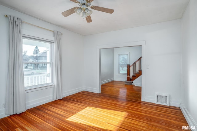 spare room with hardwood / wood-style flooring and ceiling fan