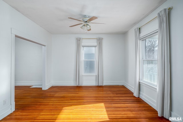 unfurnished room with hardwood / wood-style flooring, a wealth of natural light, and ceiling fan