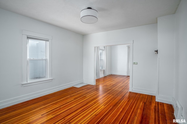 unfurnished room featuring dark hardwood / wood-style flooring