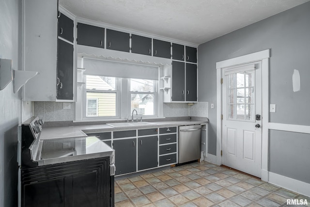 kitchen featuring stainless steel dishwasher, backsplash, sink, and a textured ceiling