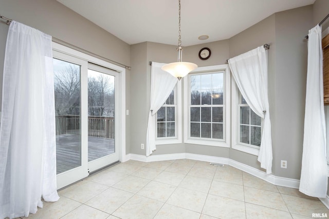 unfurnished dining area featuring light tile patterned floors