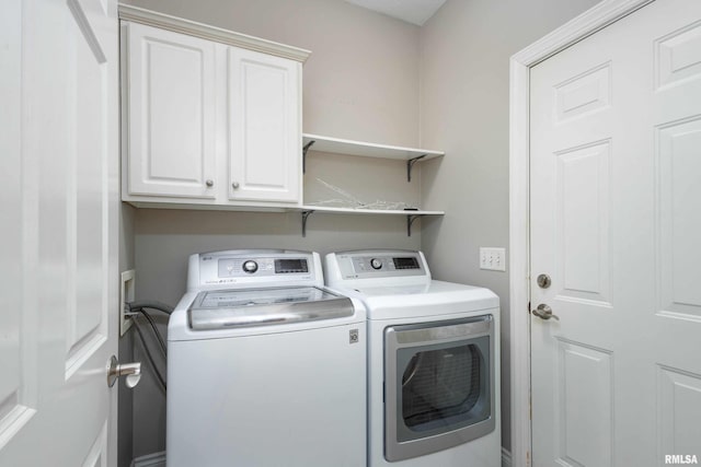 washroom featuring cabinets and independent washer and dryer