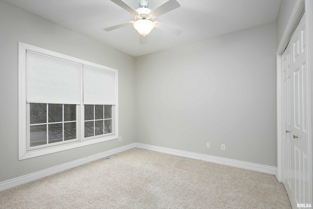 unfurnished bedroom with carpet flooring, ceiling fan, and a closet