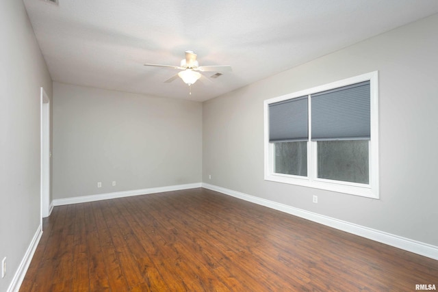 unfurnished room with dark hardwood / wood-style floors and ceiling fan