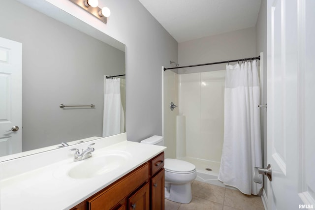 bathroom with toilet, vanity, tile patterned floors, and curtained shower