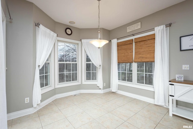 unfurnished dining area with light tile patterned floors