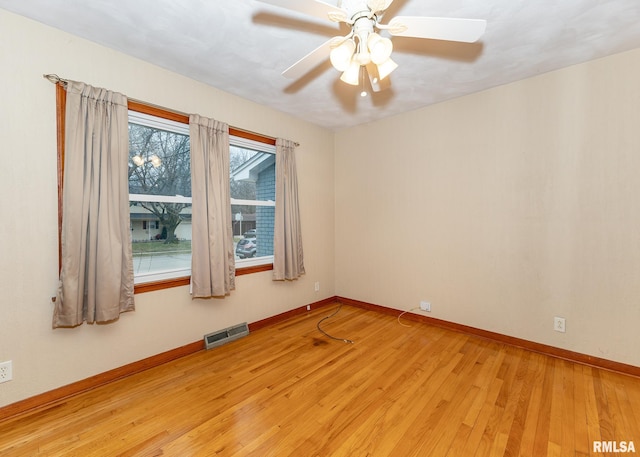 spare room with light wood-type flooring and ceiling fan