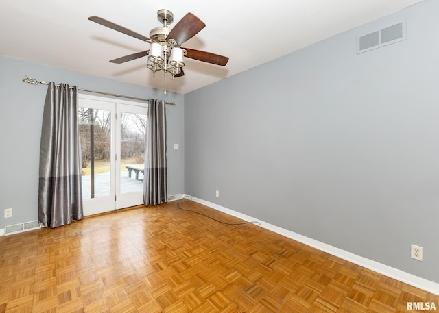 spare room featuring light parquet floors and ceiling fan