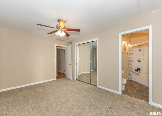 unfurnished bedroom with carpet flooring, ensuite bath, and ceiling fan