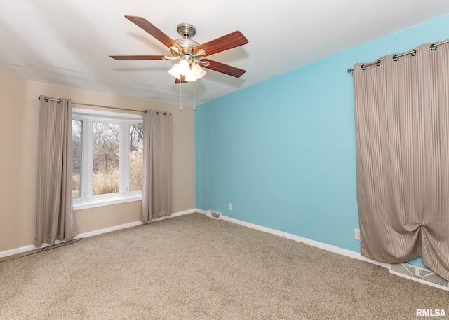 spare room featuring ceiling fan and carpet