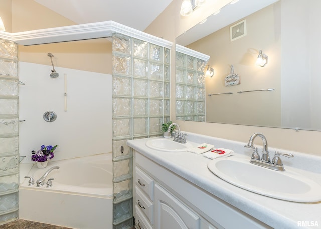 bathroom with vanity and a bath