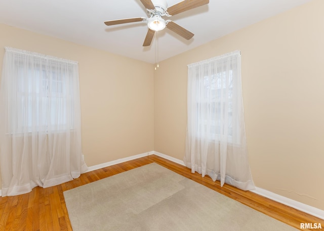 empty room featuring ceiling fan and hardwood / wood-style flooring