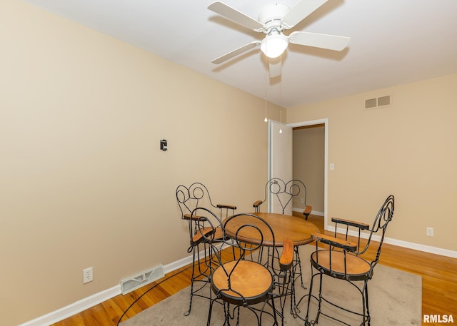 dining space featuring ceiling fan and wood-type flooring