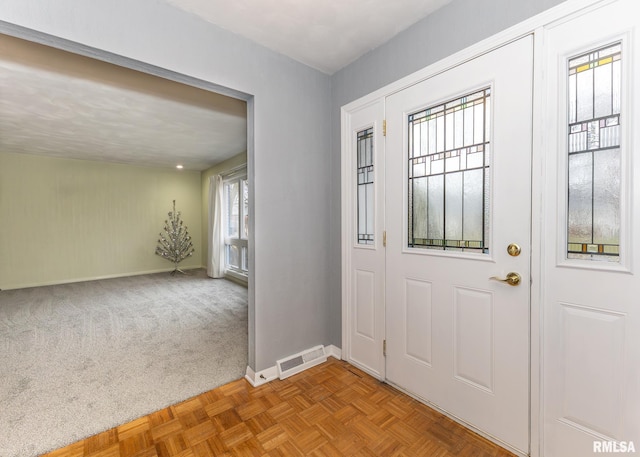 entryway featuring light carpet