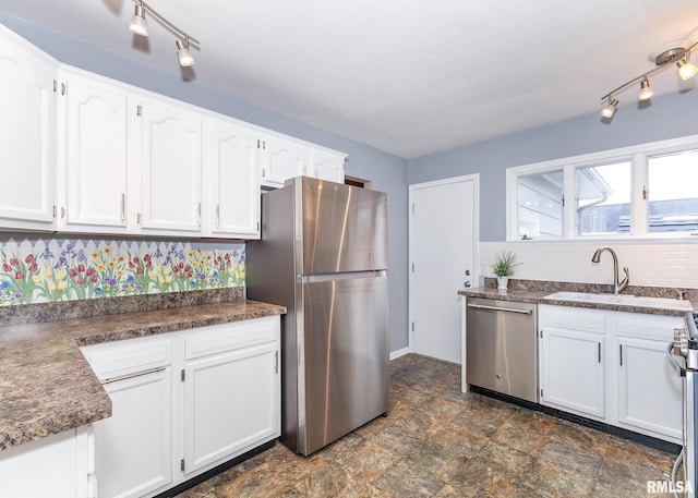 kitchen with white cabinetry, sink, and stainless steel appliances