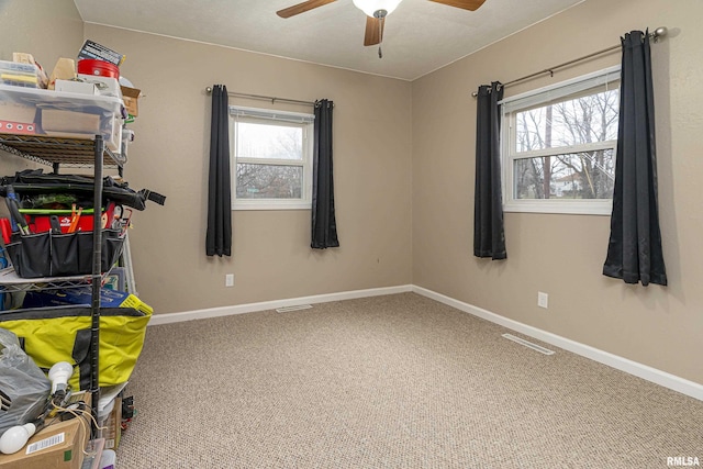 interior space with ceiling fan