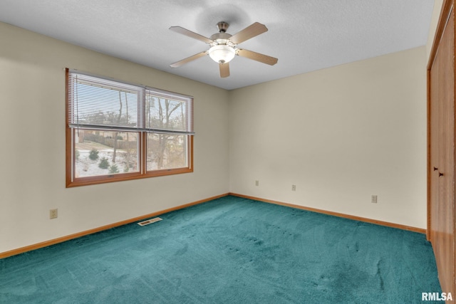 carpeted empty room with ceiling fan