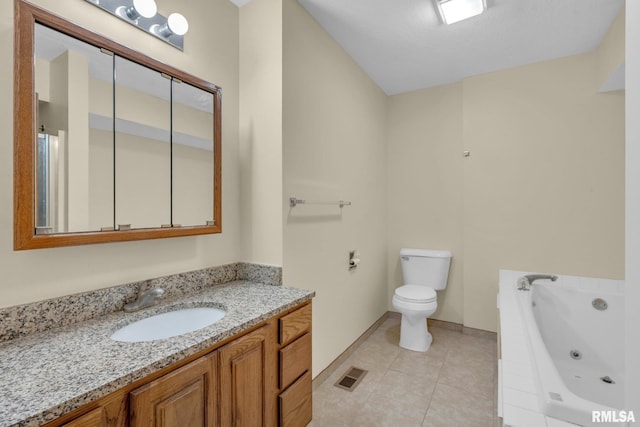 bathroom featuring tile patterned floors, a relaxing tiled tub, toilet, and vanity