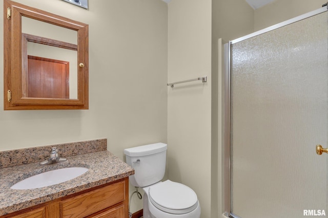 bathroom with vanity, toilet, and an enclosed shower