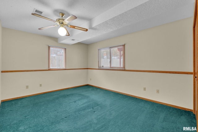 empty room featuring ceiling fan, plenty of natural light, and carpet