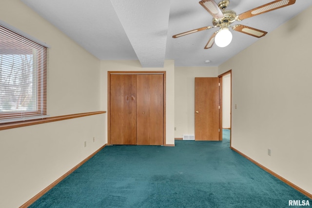 unfurnished bedroom with ceiling fan, a closet, and carpet floors