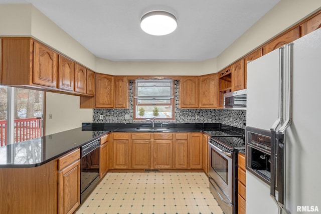 kitchen with kitchen peninsula, sink, and stainless steel appliances