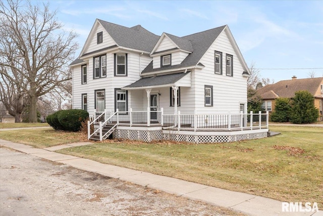 view of front of home with covered porch and a front lawn