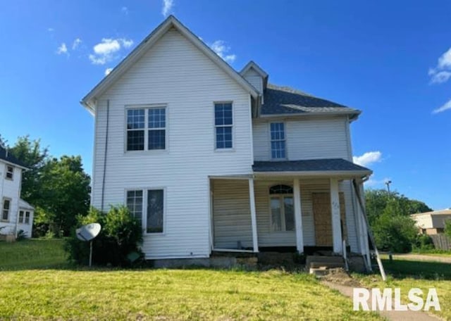 view of front of house with covered porch and a front lawn