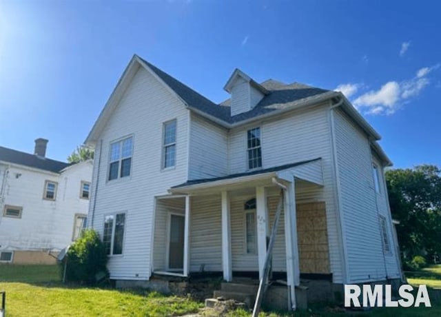 view of front of property with a porch and a front yard