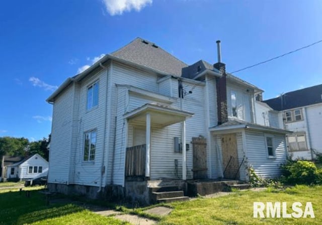 rear view of house with a lawn