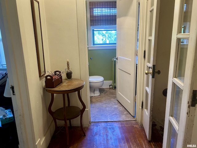 bathroom with toilet and radiator heating unit