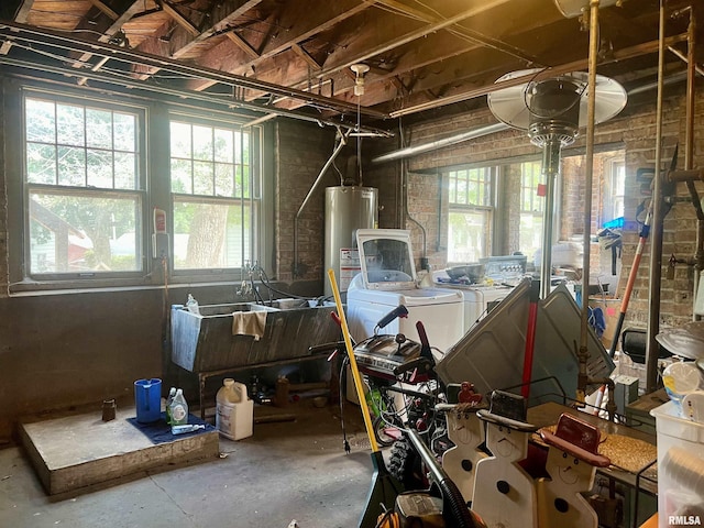 misc room with washing machine and dryer, sink, a wealth of natural light, and water heater