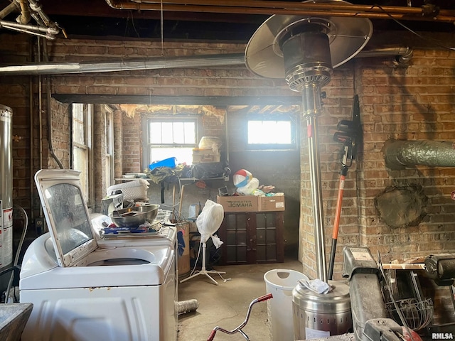 basement with washer and dryer and brick wall