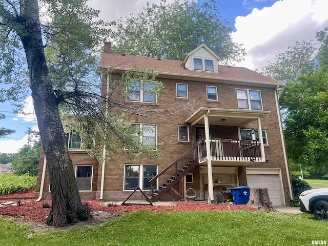 view of front of property with a front yard and a garage