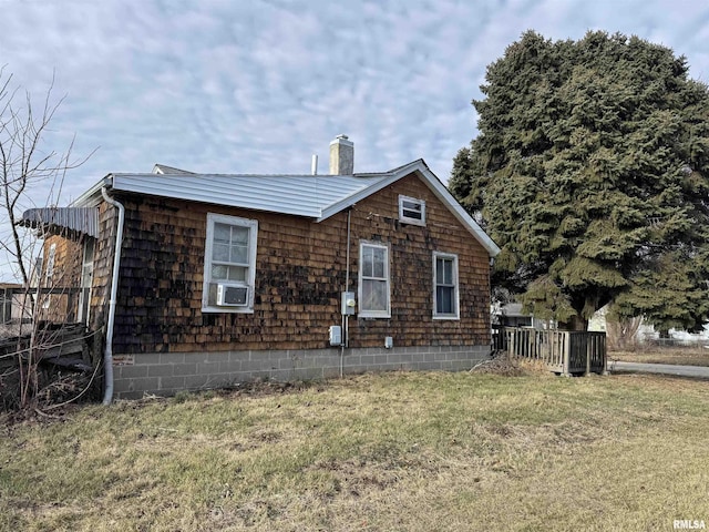 view of property exterior with a lawn and cooling unit