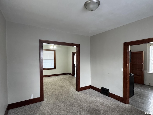 spare room with plenty of natural light and carpet floors