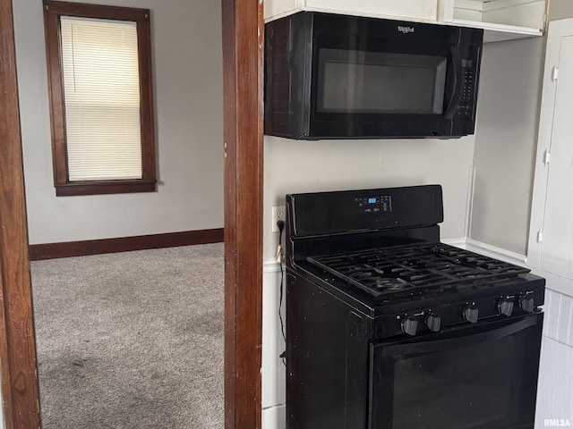 kitchen with carpet floors and black appliances