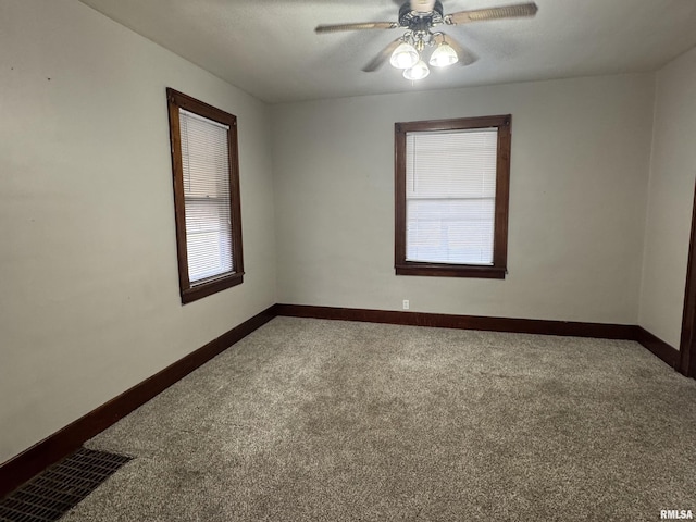 unfurnished room with ceiling fan and carpet floors