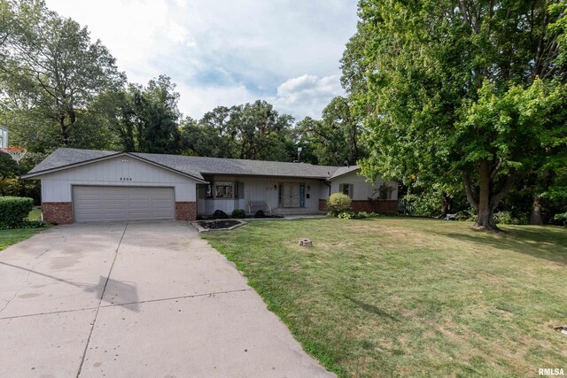 ranch-style home with a front lawn and a garage