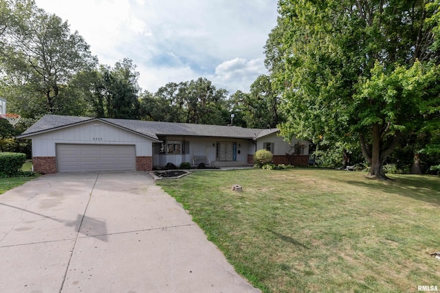 ranch-style house featuring a garage and a front yard