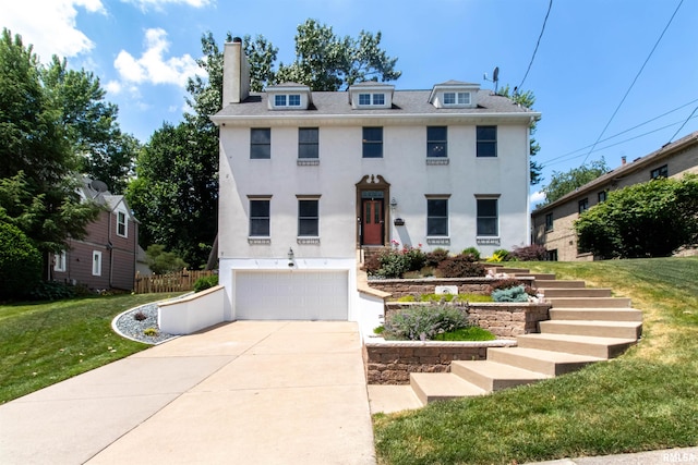 view of front of home featuring a garage and a front lawn