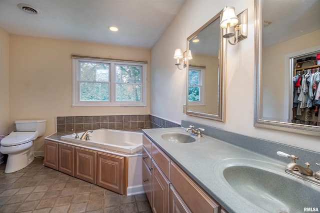 bathroom featuring vanity, toilet, and a bathtub