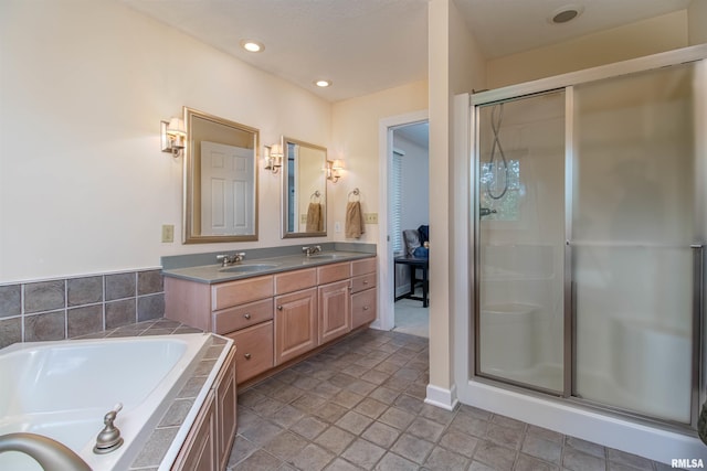 bathroom featuring vanity and independent shower and bath